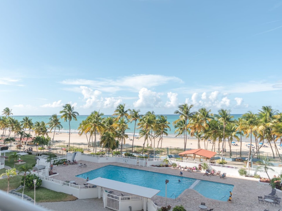 Pool, palm trees and beach at Isla Verde in Carolina, Puerto Rico
