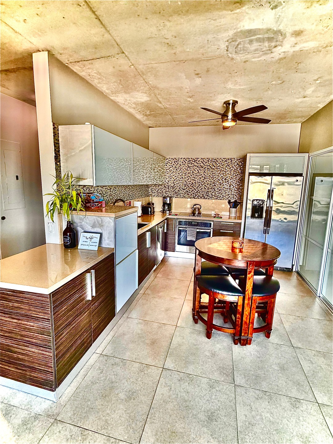Fully equipped kitchen with breakfast table in a Stay Here PR rental at Atlantis, Puerta de Tierra